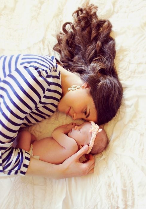 mama viendo a su hija recostada en la cama 